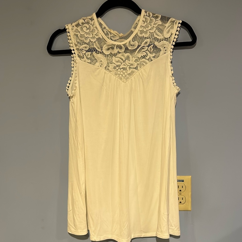 Small first look blouse, lace detail on front and back. 95% rayon 5% spandex